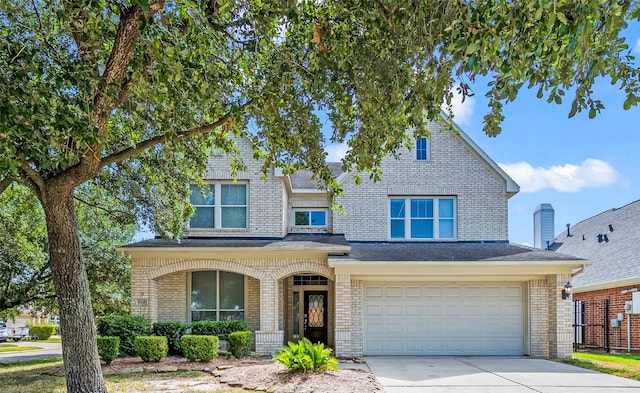 10130 Lakeside Gables Dr, Houston, TX 77065 - traditional-style home featuring covered porch, brick siding, an attached garage, a shingled roof, and driveway