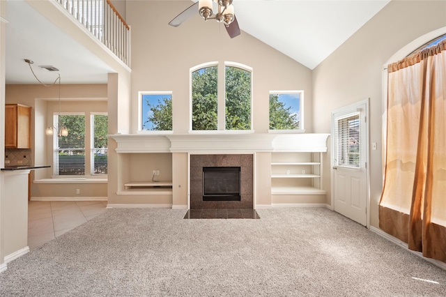 10130 Lakeside Gables Dr, Houston, TX 77065 - unfurnished living room with visible vents, ceiling fan, a fireplace, high vaulted ceiling, and carpet flooring