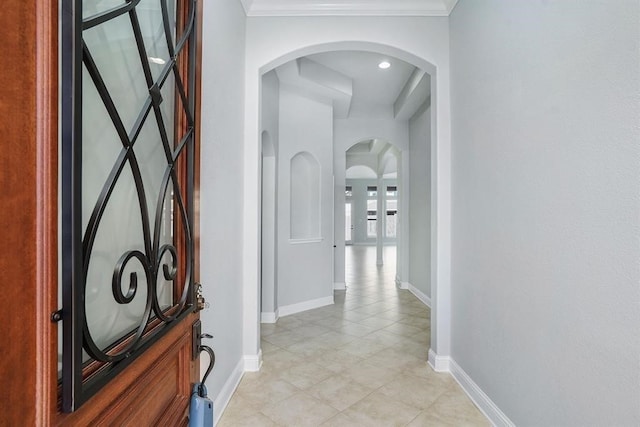 4813 Loures Ln, League City, TX 77573 - hall with arched walkways, crown molding, baseboards, and light tile patterned floors