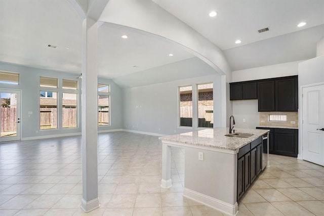 4813 Loures Ln, League City, TX 77573 - kitchen with lofted ceiling, light stone counters, visible vents, a sink, and open floor plan