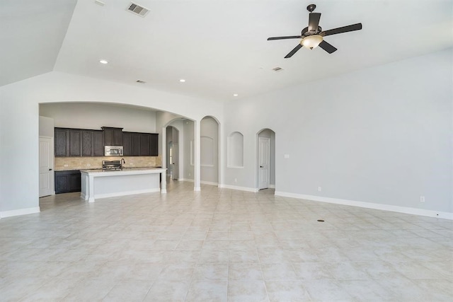 4813 Loures Ln, League City, TX 77573 - unfurnished living room with ceiling fan, arched walkways, baseboards, visible vents, and recessed lighting