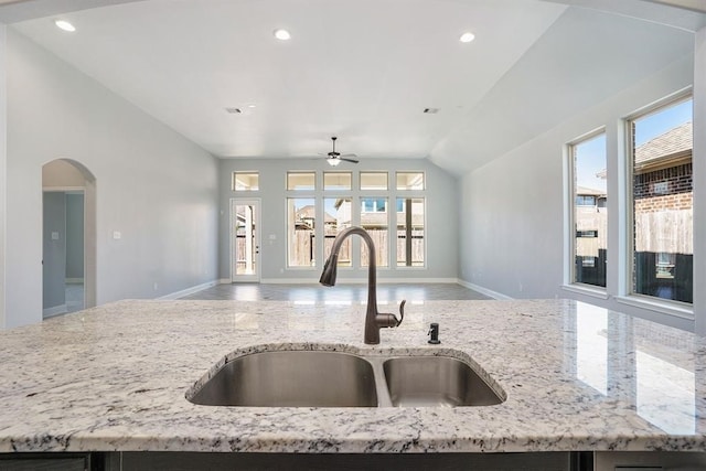 4813 Loures Ln, League City, TX 77573 - kitchen featuring vaulted ceiling, a sink, open floor plan, ceiling fan, and baseboards