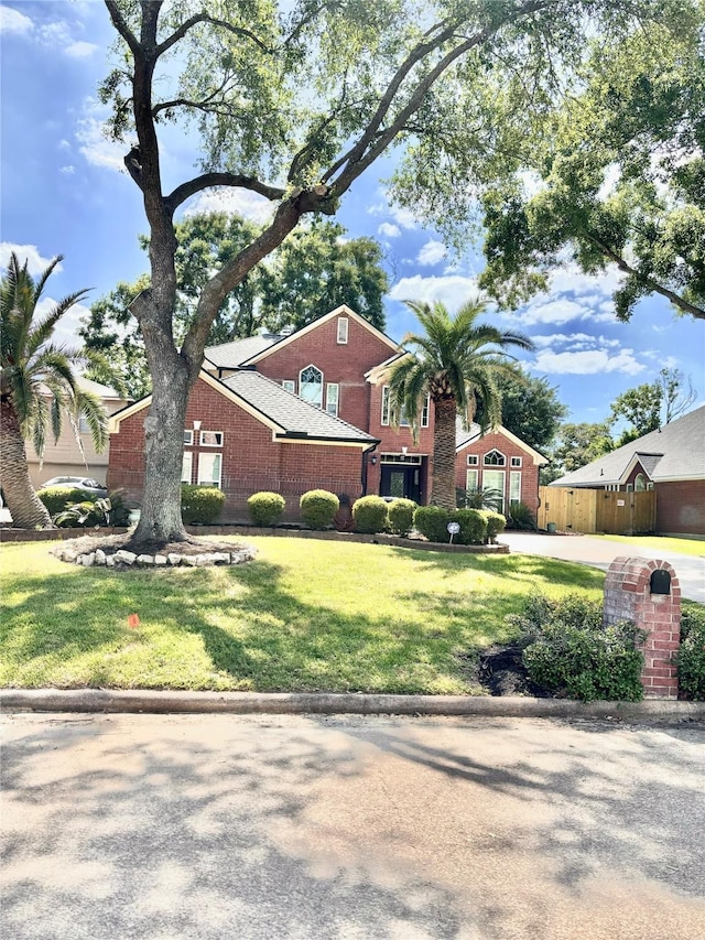 11423 Corola Trail Dr, Houston, TX 77066 - view of front of property with fence, a front lawn, and brick siding
