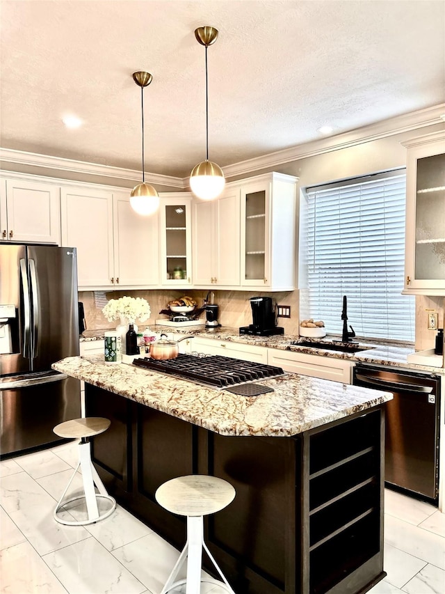 11423 Corola Trail Dr, Houston, TX 77066 - kitchen featuring ornamental molding, a kitchen island, appliances with stainless steel finishes, marble finish floor, and a sink