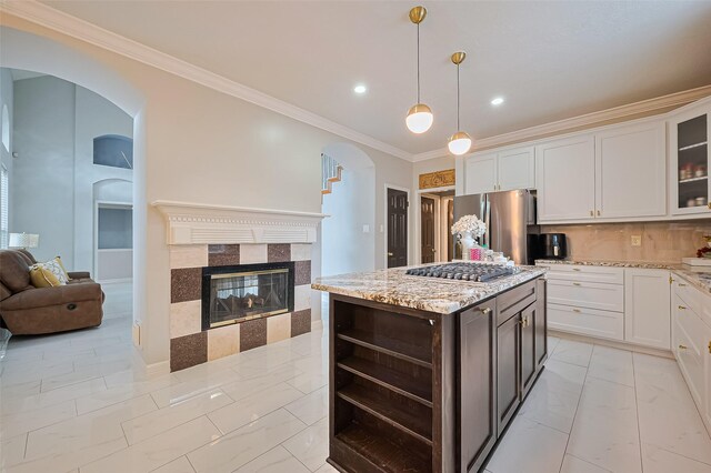11423 Corola Trail Dr, Houston, TX 77066 - kitchen with arched walkways, appliances with stainless steel finishes, crown molding, open floor plan, and white cabinetry