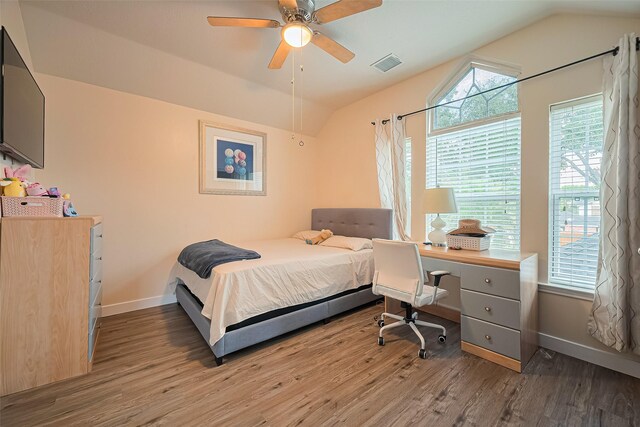 11423 Corola Trail Dr, Houston, TX 77066 - bedroom with wood finished floors, lofted ceiling, multiple windows, and a ceiling fan