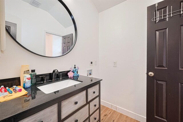 11423 Corola Trail Dr, Houston, TX 77066 - bathroom featuring wood finished floors, vanity, and vaulted ceiling