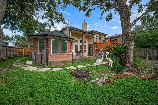 11423 Corola Trail Dr, Houston, TX 77066 - rear view of house with brick siding, a fenced backyard, a chimney, and a patio area