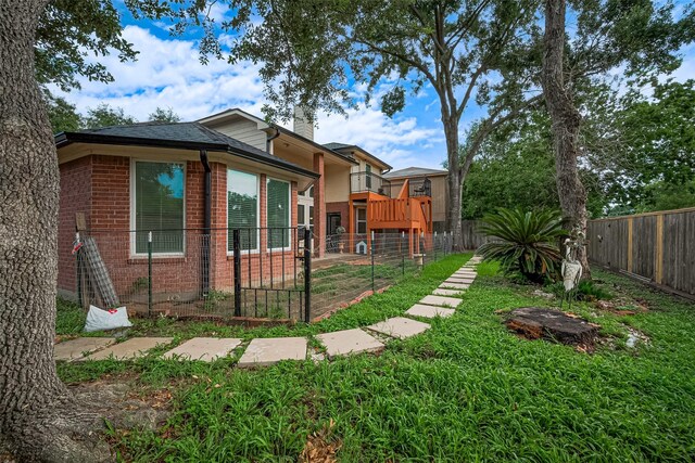 11423 Corola Trail Dr, Houston, TX 77066 - view of home's exterior featuring brick siding, a chimney, and a fenced backyard