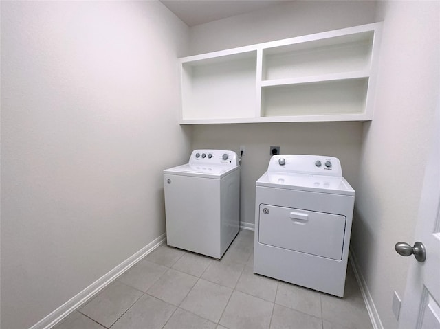 24410 Bludana Ln, Richmond, TX 77406 - laundry area featuring light tile patterned floors, washer and clothes dryer, laundry area, and baseboards