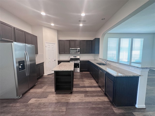 24410 Bludana Ln, Richmond, TX 77406 - kitchen featuring light stone countertops, appliances with stainless steel finishes, a sink, and visible vents