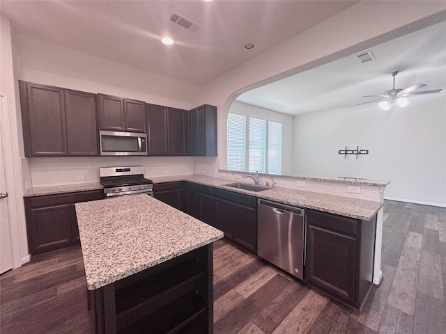 24410 Bludana Ln, Richmond, TX 77406 - kitchen featuring a peninsula, a sink, visible vents, and stainless steel appliances