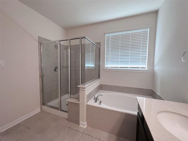 24410 Bludana Ln, Richmond, TX 77406 - full bathroom with a bath, vanity, tile patterned flooring, a stall shower, and baseboards