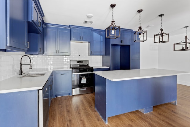 kitchen with dark wood-style flooring, a sink, visible vents, and stainless steel appliances