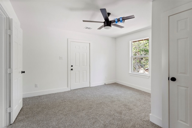 unfurnished bedroom featuring visible vents, baseboards, carpet flooring, and ceiling fan