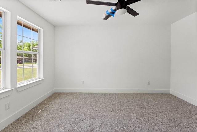 unfurnished room featuring carpet flooring, baseboards, and ceiling fan