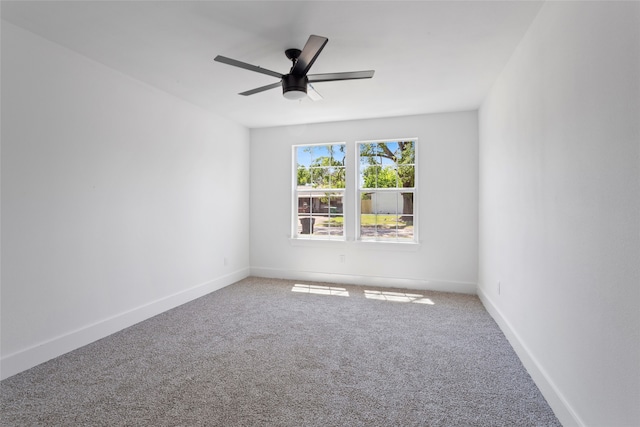 spare room featuring carpet flooring, baseboards, and a ceiling fan