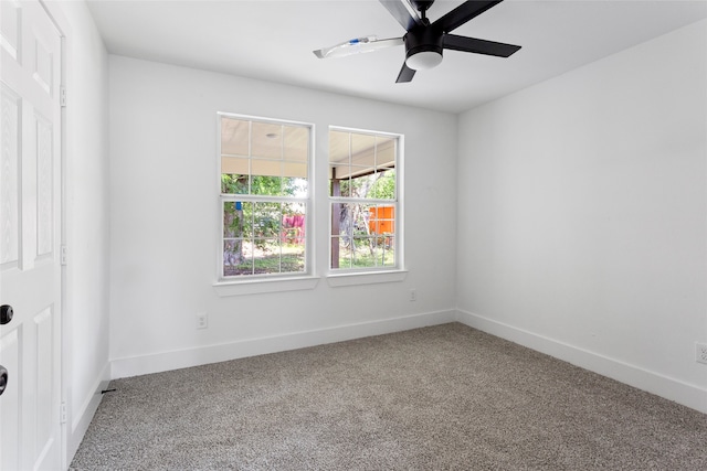 carpeted empty room featuring baseboards and ceiling fan