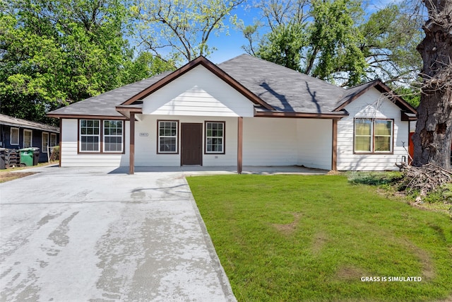 ranch-style house with concrete driveway and a front lawn