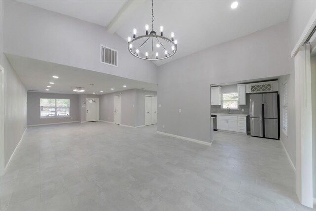 3605 Barberry Dr, Houston, TX 77051 - interior space with a chandelier, visible vents, beam ceiling, high vaulted ceiling, and a sink
