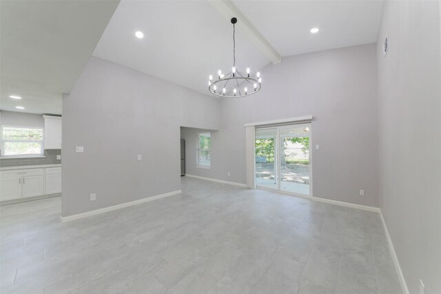 3605 Barberry Dr, Houston, TX 77051 - empty room with beam ceiling, baseboards, an inviting chandelier, and a healthy amount of sunlight