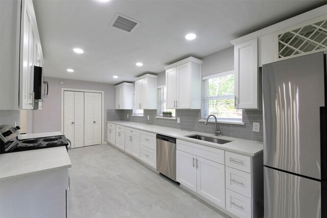 3605 Barberry Dr, Houston, TX 77051 - kitchen with stainless steel appliances, visible vents, a sink, and decorative backsplash