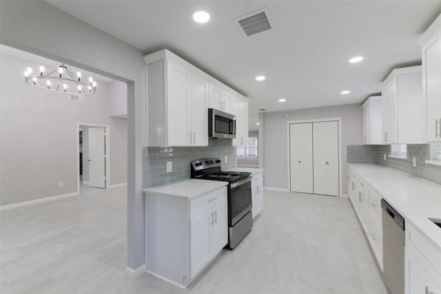 3605 Barberry Dr, Houston, TX 77051 - kitchen with an inviting chandelier, visible vents, light countertops, stainless steel appliances, and backsplash