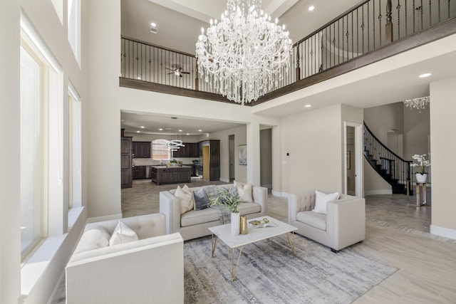 26406 Crimson Bluff Ln, Katy, TX 77494 - living room featuring a high ceiling, recessed lighting, a chandelier, and stairs