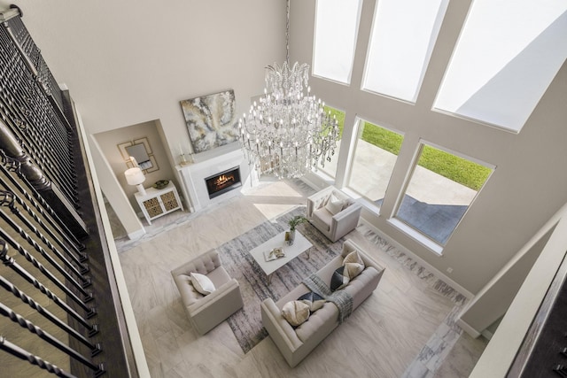 26406 Crimson Bluff Ln, Katy, TX 77494 - living area featuring a chandelier, marble finish floor, a high ceiling, and a premium fireplace