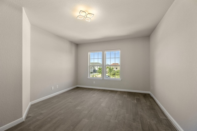 26406 Crimson Bluff Ln, Katy, TX 77494 - empty room featuring baseboards and dark wood-style floors