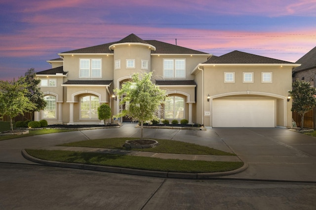 26406 Crimson Bluff Ln, Katy, TX 77494 - view of front of house featuring an attached garage, curved driveway, and stucco siding