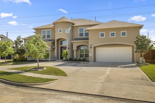 26406 Crimson Bluff Ln, Katy, TX 77494 - mediterranean / spanish house with stucco siding, driveway, a garage, fence, and a shingled roof