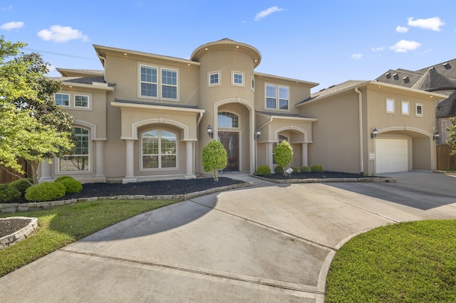 26406 Crimson Bluff Ln, Katy, TX 77494 - mediterranean / spanish home featuring an attached garage, concrete driveway, and stucco siding
