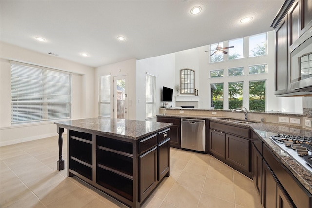 kitchen featuring a sink, plenty of natural light, dark brown cabinetry, and stainless steel appliances