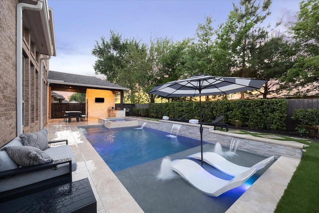 view of swimming pool featuring a fenced backyard, a pool with connected hot tub, and a patio area