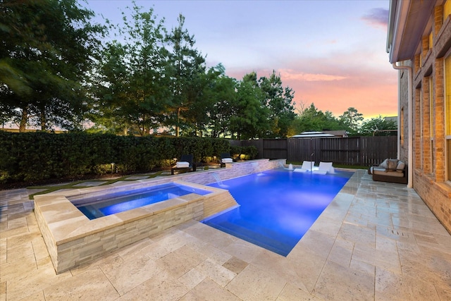 view of swimming pool with a fenced in pool, a fenced backyard, an in ground hot tub, and a patio area
