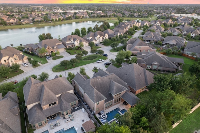 bird's eye view with a residential view and a water view