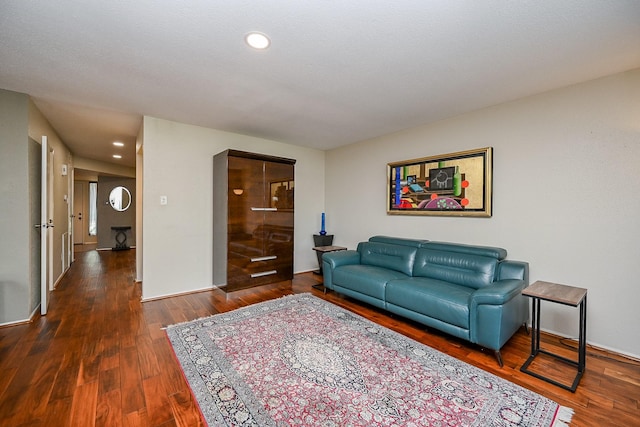 living area with recessed lighting and wood finished floors