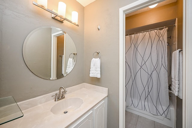 bathroom featuring tile patterned flooring, a shower with shower curtain, and vanity