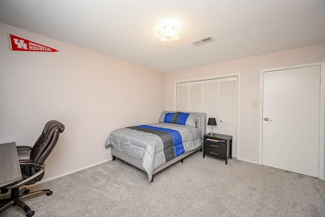 bedroom with visible vents, a closet, baseboards, and carpet floors