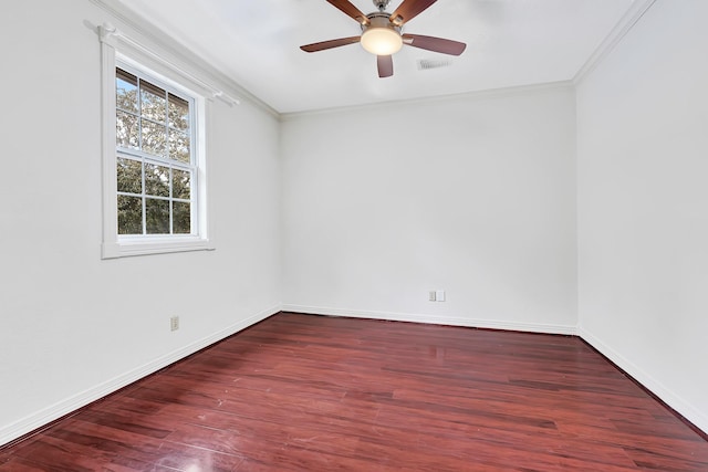 unfurnished room featuring baseboards, crown molding, and wood finished floors