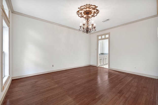 unfurnished room featuring visible vents, baseboards, ornamental molding, a chandelier, and wood finished floors