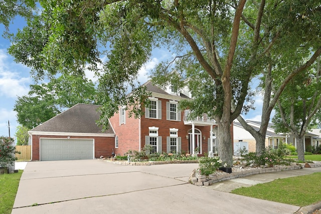 view of front of house featuring concrete driveway, brick siding, and a garage