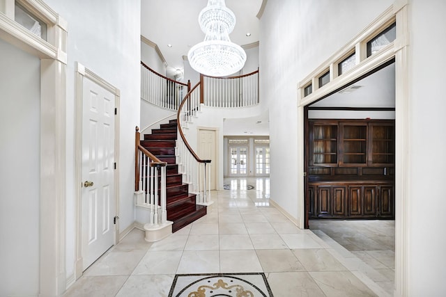 4618 Sao Paulo St, Pasadena, TX 77504 - entryway with stairs, baseboards, a chandelier, a towering ceiling, and crown molding