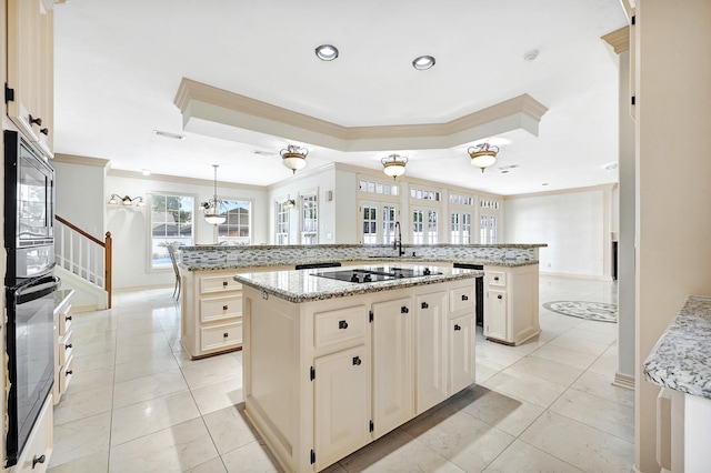 kitchen with oven, backsplash, a large island, and ornamental molding