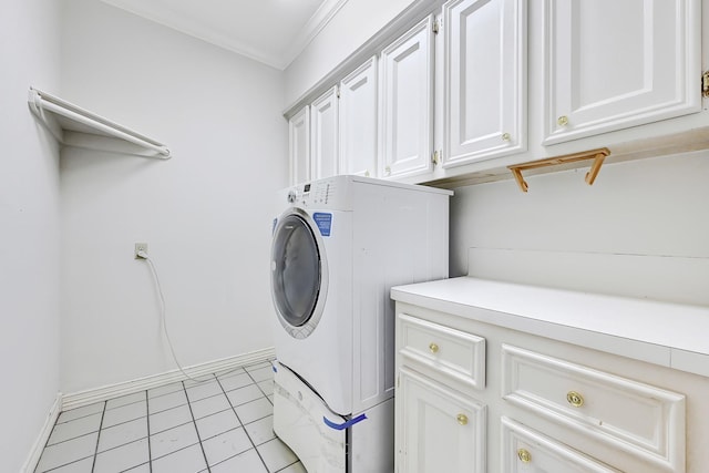 laundry area featuring cabinet space, washer / clothes dryer, baseboards, and light tile patterned floors
