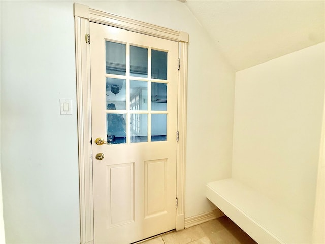 mudroom with lofted ceiling and light tile patterned floors