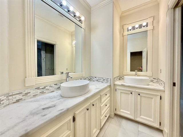 full bath with two vanities, crown molding, decorative backsplash, and a sink