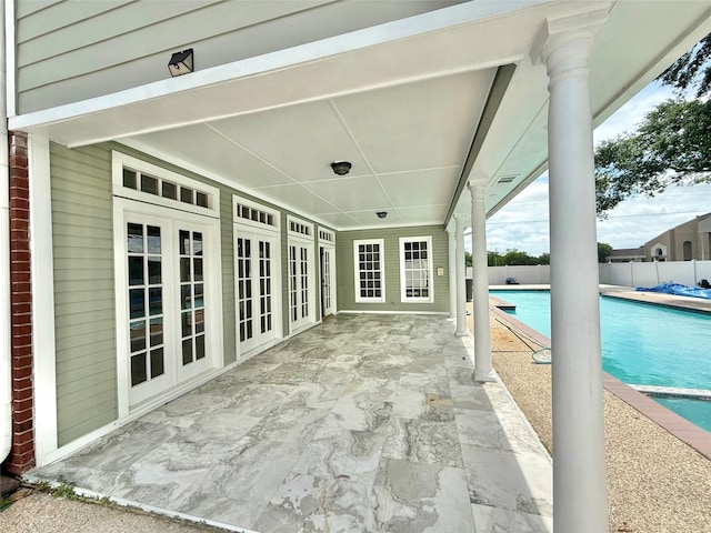 view of patio with french doors, a fenced in pool, and fence
