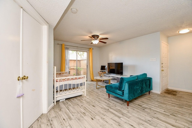 10555 Turtlewood Ct Unit 2606, Houston, TX 77072 - bedroom with a textured ceiling, wood finished floors, and baseboards
